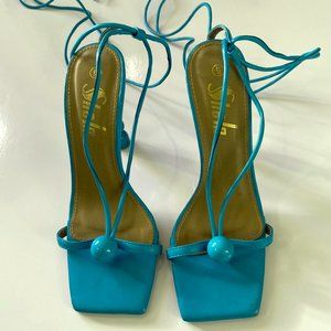 Turquoise blue lace up, strappy heels. Worn once